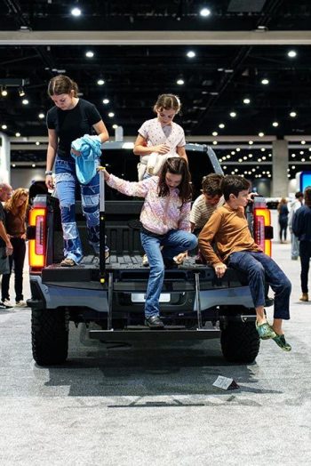 The kids are entertained while the parents comparison shop, a scene repeated over and over throughout the San Diego Auto Show.